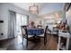 Well-lit dining room with dark wood floors and view into the kitchen at 3266 Greenhill Ct, Villa Rica, GA 30180