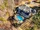 A beautiful estate featuring a backyard oasis with pool, patio, fire pit, and mature trees at 709 Prestige Pt, Peachtree City, GA 30269