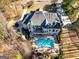 Stunning aerial view of a large home with a pool, deck, and landscaped backyard at 709 Prestige Pt, Peachtree City, GA 30269