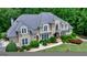 High angle of a meticulously landscaped home with manicured lawn and surrounding mature hardwood trees at 709 Prestige Pt, Peachtree City, GA 30269