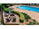 Relax in this backyard featuring a fire pit, pool, and lounge chairs surrounded by lush landscaping at 709 Prestige Pt, Peachtree City, GA 30269