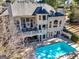 This backyard features a pool with patio, deck, and lush landscaping at 709 Prestige Pt, Peachtree City, GA 30269