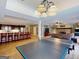 Entertain in this spacious finished basement featuring a kitchen, game room with stone fireplace and ping pong at 709 Prestige Pt, Peachtree City, GA 30269