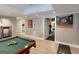 Finished basement featuring a billiards room and a doorway leading to a home gym with modern fitness equipment at 709 Prestige Pt, Peachtree City, GA 30269