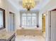 Luxurious bathroom with large tub and natural light from arched windows at 709 Prestige Pt, Peachtree City, GA 30269