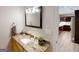 A well-lit bathroom features a granite countertop, decorative mirror, and modern vanity at 709 Prestige Pt, Peachtree City, GA 30269