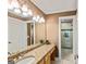 Bathroom features a large mirror, vanity with granite countertop, and walk-in shower at 709 Prestige Pt, Peachtree City, GA 30269