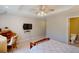 Relaxing bedroom with light color palette, desk, and en suite bathroom access at 709 Prestige Pt, Peachtree City, GA 30269