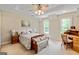 Comfortable bedroom with tray ceiling, ceiling fan, and a wooden desk by bright windows at 709 Prestige Pt, Peachtree City, GA 30269