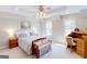 Cozy bedroom with neutral tones, comfortable bed, and wooden desk area at 709 Prestige Pt, Peachtree City, GA 30269