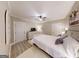 Rest easy in this bedroom featuring wood-look floors, a ceiling fan and neutral colors at 709 Prestige Pt, Peachtree City, GA 30269