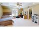 Cozy bedroom featuring large window, ceiling fan, and open closet at 709 Prestige Pt, Peachtree City, GA 30269