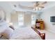 Well-lit bedroom features a comfortable bed, desk, and built in media center at 709 Prestige Pt, Peachtree City, GA 30269