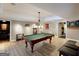 Entertain in this spacious recreation room with a classic billiards table and custom lighting, adjacent to a game room at 709 Prestige Pt, Peachtree City, GA 30269