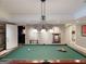 Entertain in this rec room with a classic billiards table and custom lighting, adjacent to a comfortable lounge at 709 Prestige Pt, Peachtree City, GA 30269