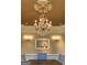 Close-up of dining room chandelier with decorative ceiling and lighting at 709 Prestige Pt, Peachtree City, GA 30269