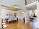 Open dining room showcasing hardwood floors, chandelier, and an archway leading to the living room at 709 Prestige Pt, Peachtree City, GA 30269