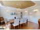 The dining room features a decorative chandelier, mirror, and a table set for eight guests at 709 Prestige Pt, Peachtree City, GA 30269
