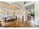 Open-concept dining room with chandelier, hardwood floors, and views to the living room at 709 Prestige Pt, Peachtree City, GA 30269