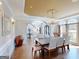 A dining room showing hardwood floors, an elegant chandelier, and a table set for eight guests at 709 Prestige Pt, Peachtree City, GA 30269