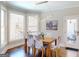 Bright dining area with a modern light fixture, large windows, and a view of the deck at 709 Prestige Pt, Peachtree City, GA 30269