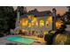 Luxury home exterior with a backyard pool at dusk at 709 Prestige Pt, Peachtree City, GA 30269