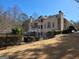 Backyard with well-maintained landscaping, fence, mature trees, and beautiful rear architecture at 709 Prestige Pt, Peachtree City, GA 30269