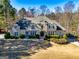 Handsome two-story home with stone and stucco exterior, lush landscaping, and a well-maintained lawn at 709 Prestige Pt, Peachtree City, GA 30269