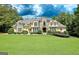 Stunning two-story home with a manicured lawn and beautiful stone and stucco exterior at 709 Prestige Pt, Peachtree City, GA 30269