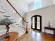 Elegant foyer featuring hardwood floors, stairs, and an ornate front door at 709 Prestige Pt, Peachtree City, GA 30269