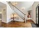 Bright foyer with hardwood floors, staircase, and elegant lighting at 709 Prestige Pt, Peachtree City, GA 30269