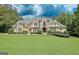 Beautiful home with a manicured front lawn and a combination stone and siding facade at 709 Prestige Pt, Peachtree City, GA 30269