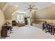 Game room has ceiling fan, large window, arm chair, couch, desk and piano at 709 Prestige Pt, Peachtree City, GA 30269