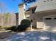 Rear view of a stucco house featuring a two-car garage, backyard fence, and manicured lawn at 709 Prestige Pt, Peachtree City, GA 30269