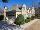 Charming home showcasing a two-car garage, lush landscaping, and a stucco exterior at 709 Prestige Pt, Peachtree City, GA 30269