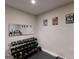 This home gym is complete with dumbbells, a mirror, and workout equipment for exercise at 709 Prestige Pt, Peachtree City, GA 30269
