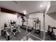 The home gym includes a treadmill and various weight machines for a complete workout experience at 709 Prestige Pt, Peachtree City, GA 30269