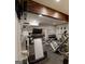 Well-equipped home gym offers various machines, weights, and mirrors for a complete workout at 709 Prestige Pt, Peachtree City, GA 30269