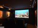 Relax in style in this home theater with a large screen and comfortable leather recliners at 709 Prestige Pt, Peachtree City, GA 30269