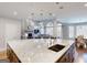 Spacious kitchen with a marble island, stone fireplace, and an open floor plan at 709 Prestige Pt, Peachtree City, GA 30269