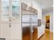 Elegant kitchen features white cabinets, stainless steel appliances, and glass display cabinets at 709 Prestige Pt, Peachtree City, GA 30269