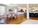 Open concept kitchen with a marble island, pendant lights, and hardwood floors at 709 Prestige Pt, Peachtree City, GA 30269