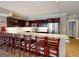 Kitchen bar features modern seating, stainless steel appliances, custom cabinets, and marble countertops at 709 Prestige Pt, Peachtree City, GA 30269