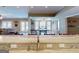 View from kitchen island to recreation room and view of the outdoor swimming pool through french doors at 709 Prestige Pt, Peachtree City, GA 30269