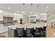 Large kitchen island features marble countertops, pendant lighting, and seating for four at 709 Prestige Pt, Peachtree City, GA 30269