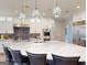 Open kitchen features stainless steel appliances, modern light fixtures, and a large island at 709 Prestige Pt, Peachtree City, GA 30269