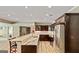 Kitchen features a long island with seating, dark wood cabinetry and stainless-steel appliances at 709 Prestige Pt, Peachtree City, GA 30269