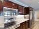 Modern kitchen features stainless steel appliances, tile backsplash, and custom cabinetry for ample storage at 709 Prestige Pt, Peachtree City, GA 30269