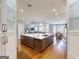 Spacious gourmet kitchen featuring a large marble island and an open floor plan with a dining area and living room at 709 Prestige Pt, Peachtree City, GA 30269