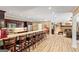Basement kitchenette with bar seating, stainless appliances, and open access to the game room at 709 Prestige Pt, Peachtree City, GA 30269